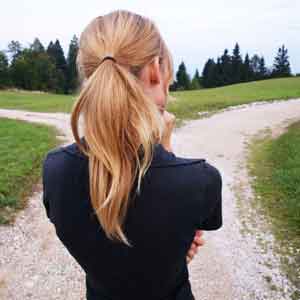  A woman looking at a forked road, to choose the right drug rehab.