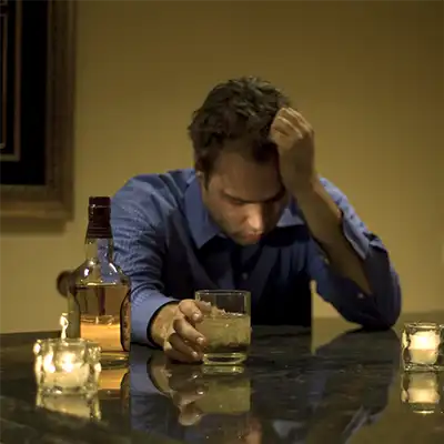  A man drinking alcohol alone.