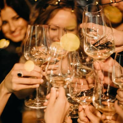 Women cheering with wine glass. Needing an addiction rehab.